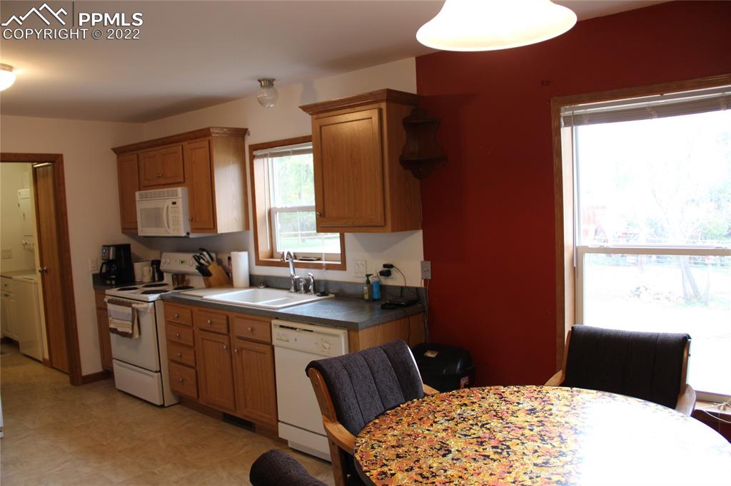 749 9th Street Calhan, CO 80808 - Photo 7 of 43 a kitchen with a sink a window and cabinets