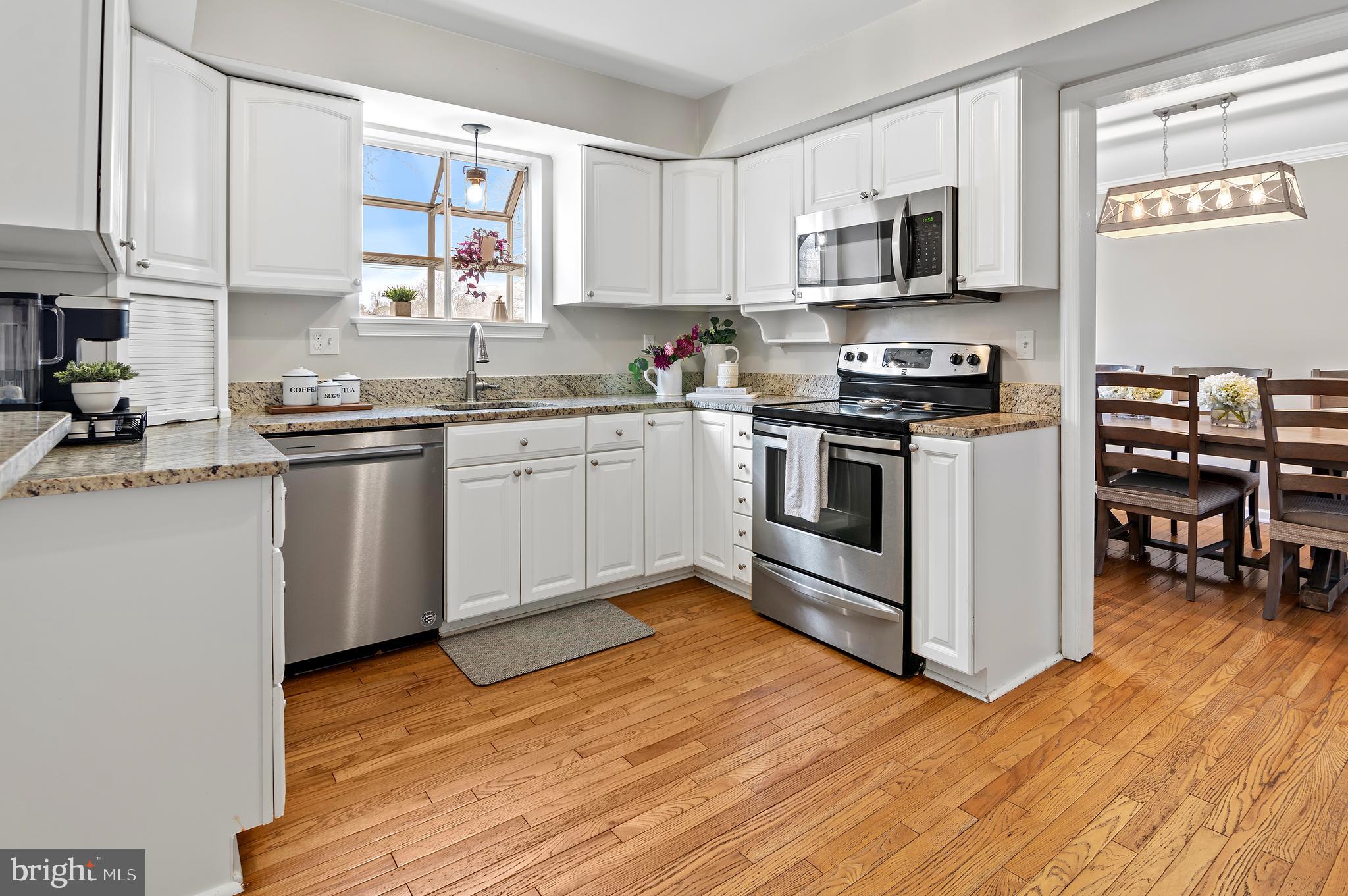 40 Dorba Court Severna Park, MD 21146 - Photo 12 of 67 a kitchen with stainless steel appliances granite countertop a stove top oven a sink and a microwave