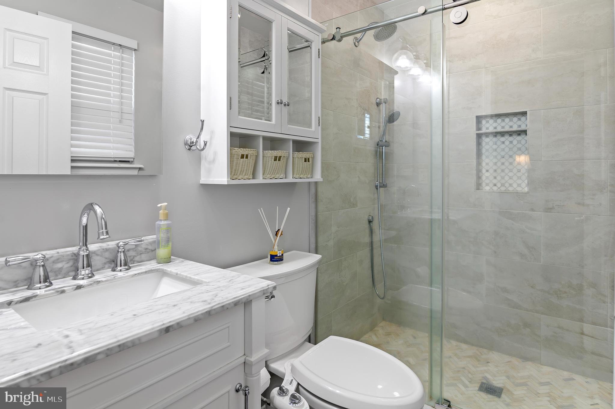 40 Dorba Court Severna Park, MD 21146 - Photo 28 of 67 a bathroom with a granite countertop sink toilet a mirror a shower and a window