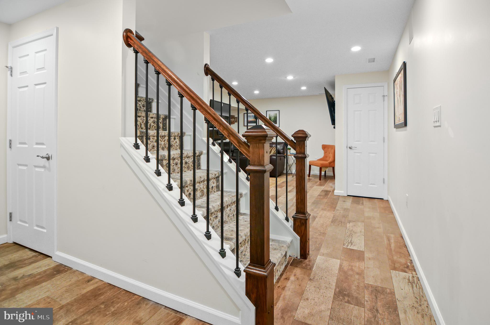 40 Dorba Court Severna Park, MD 21146 - Photo 40 of 67 a view of staircase with lots of frames on wall and wooden floor