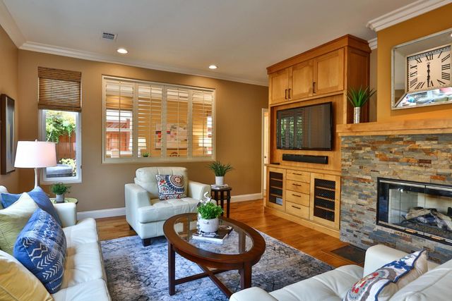 a living room with fireplace furniture and a flat screen tv