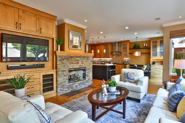 a living room with furniture fireplace and a large window