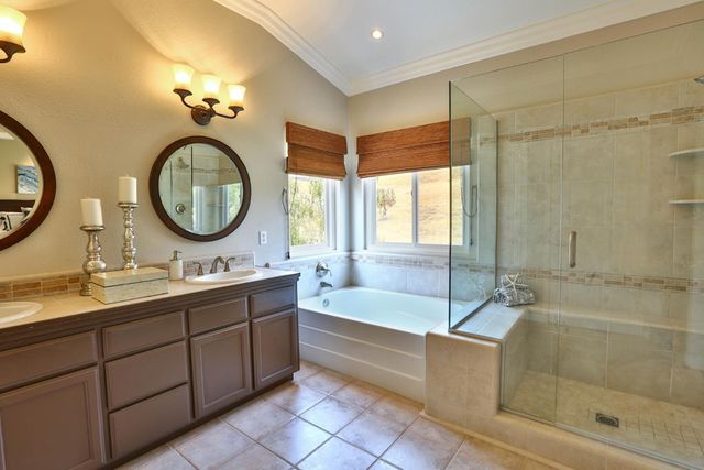 a bathroom with a double vanity sink and a mirror