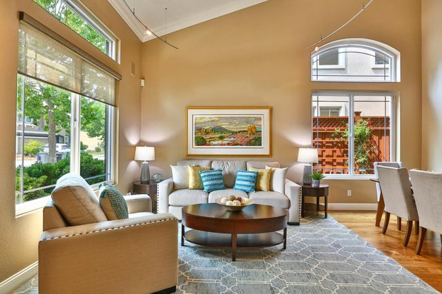 a living room with fireplace furniture and a large window