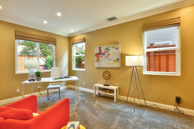 a living room with furniture a large window and a wooden floor