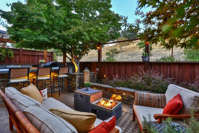 an outdoor living space with furniture and city view
