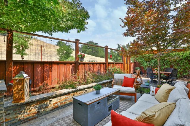 a view of a balcony with furniture and umbrella