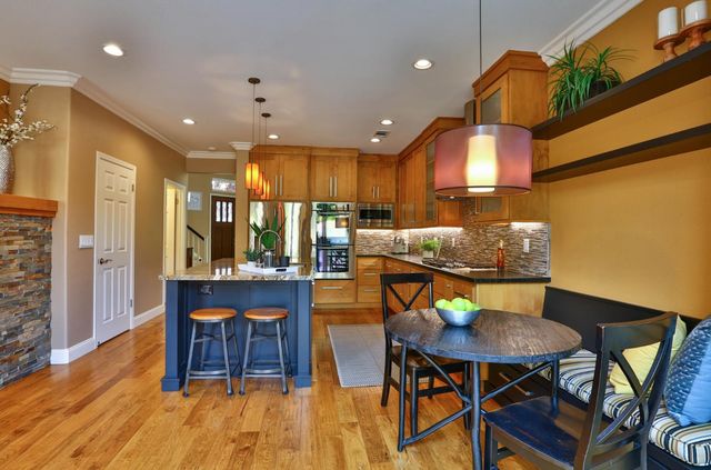 a view of a a dining room with furniture window and wooden floor