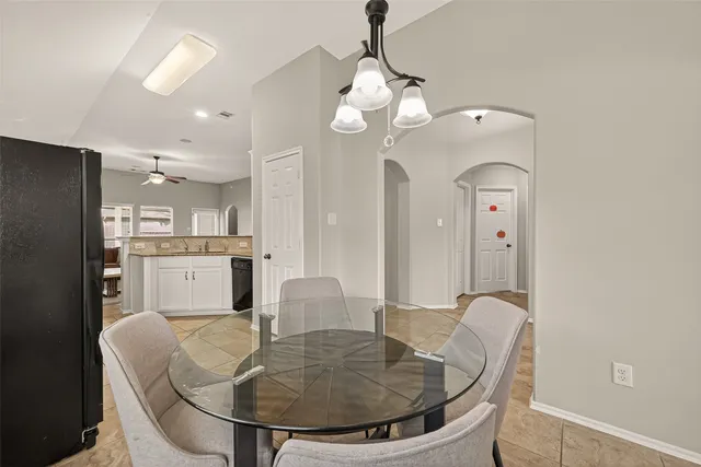 a living room with dining table and couches