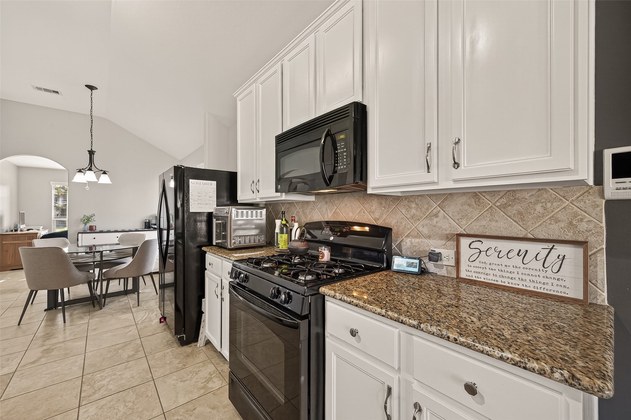 15607 Mossy Park Cypress, TX 77429 - Photo 13 of 34 a kitchen with stainless steel appliances granite countertop a stove a sink and a microwave