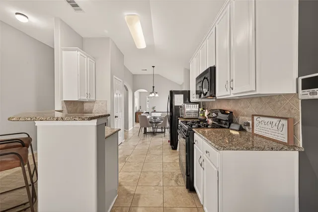 a kitchen with a sink stove and cabinets