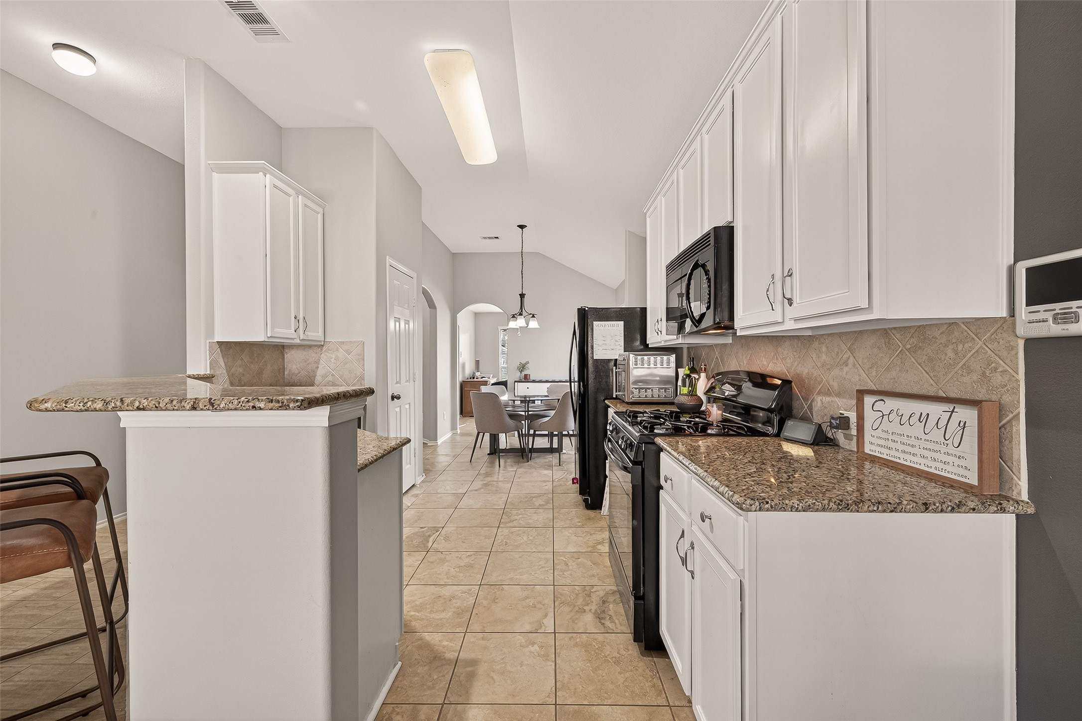 15607 Mossy Park Cypress, TX 77429 - Photo 14 of 34 a kitchen with a sink stove and cabinets
