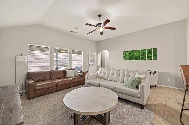 a living room with furniture and a large window