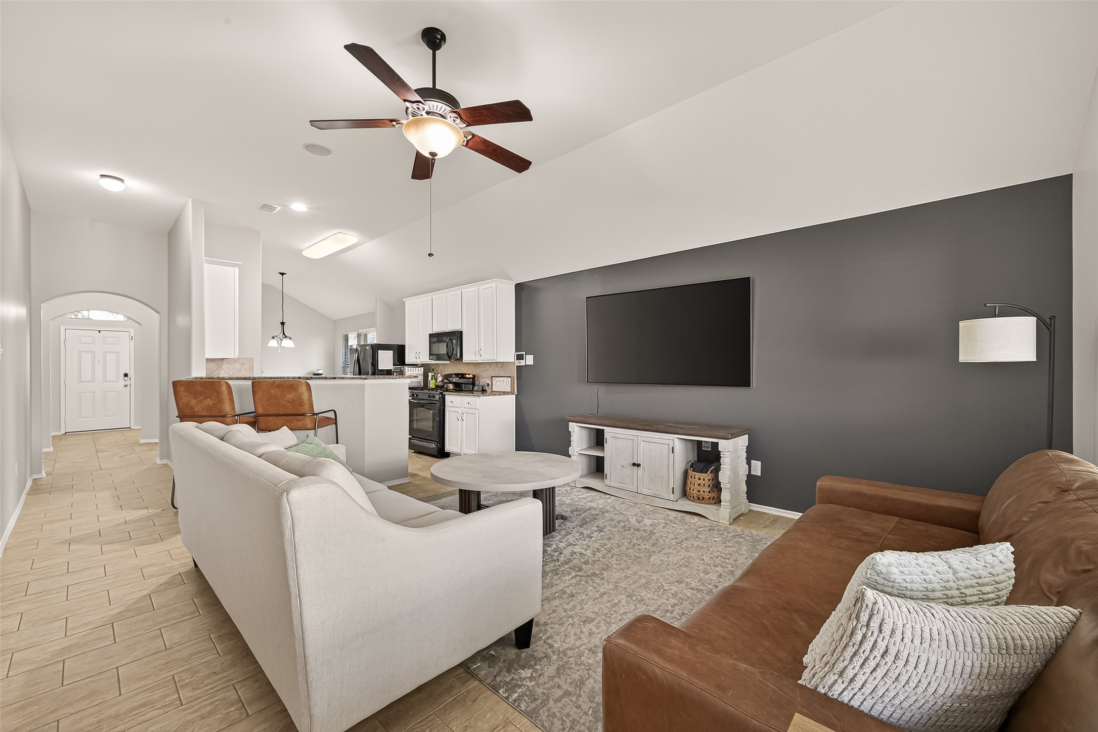 15607 Mossy Park Cypress, TX 77429 - Photo 20 of 34 a living room with furniture kitchen view and a flat screen tv