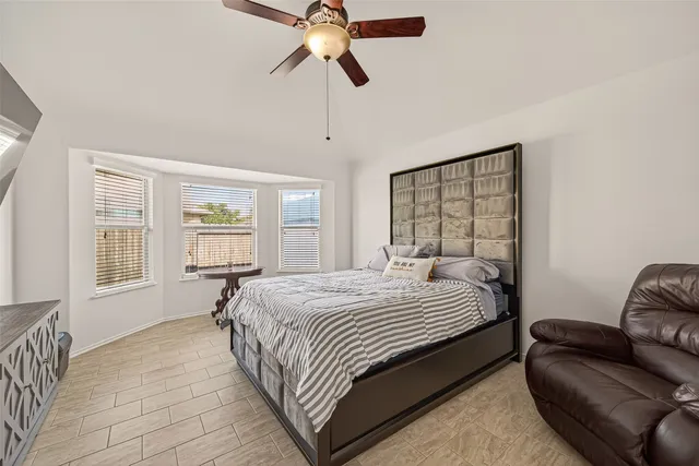 a bedroom with a bed couch and window