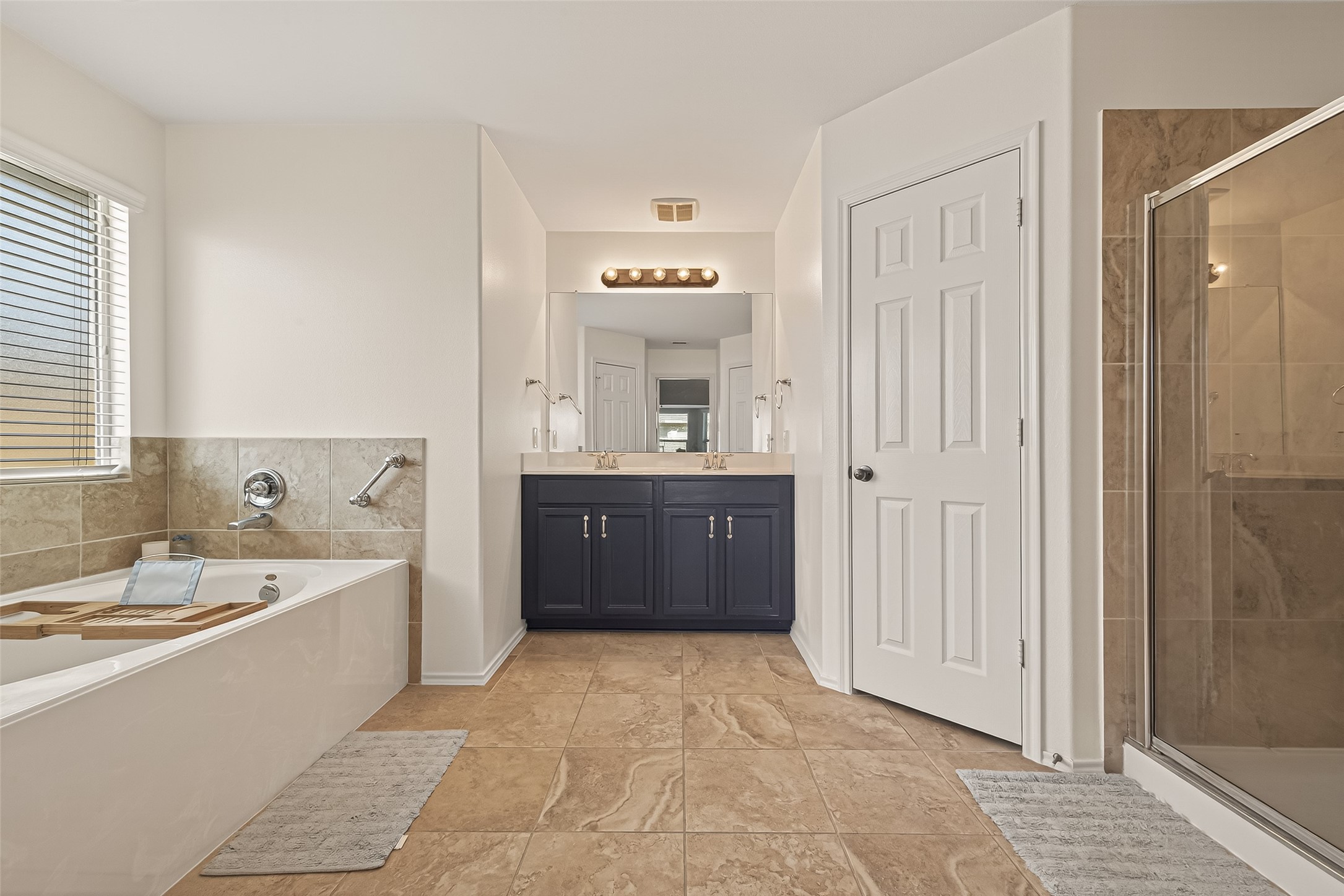 15607 Mossy Park Cypress, TX 77429 - Photo 23 of 34 a spacious bathroom with a bathtub sink and mirror