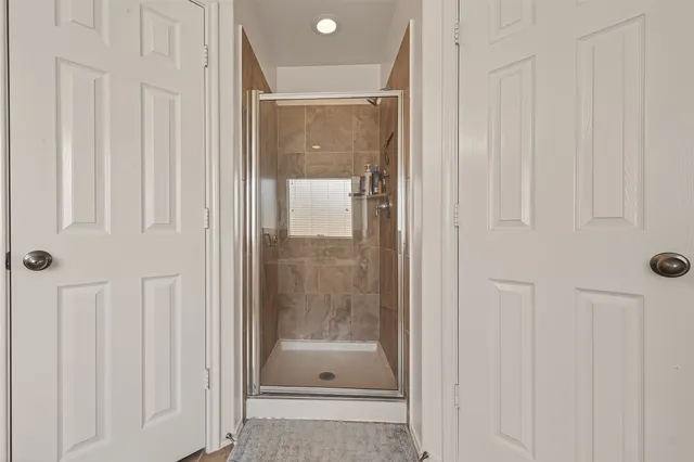 a bathroom with a glass shower door