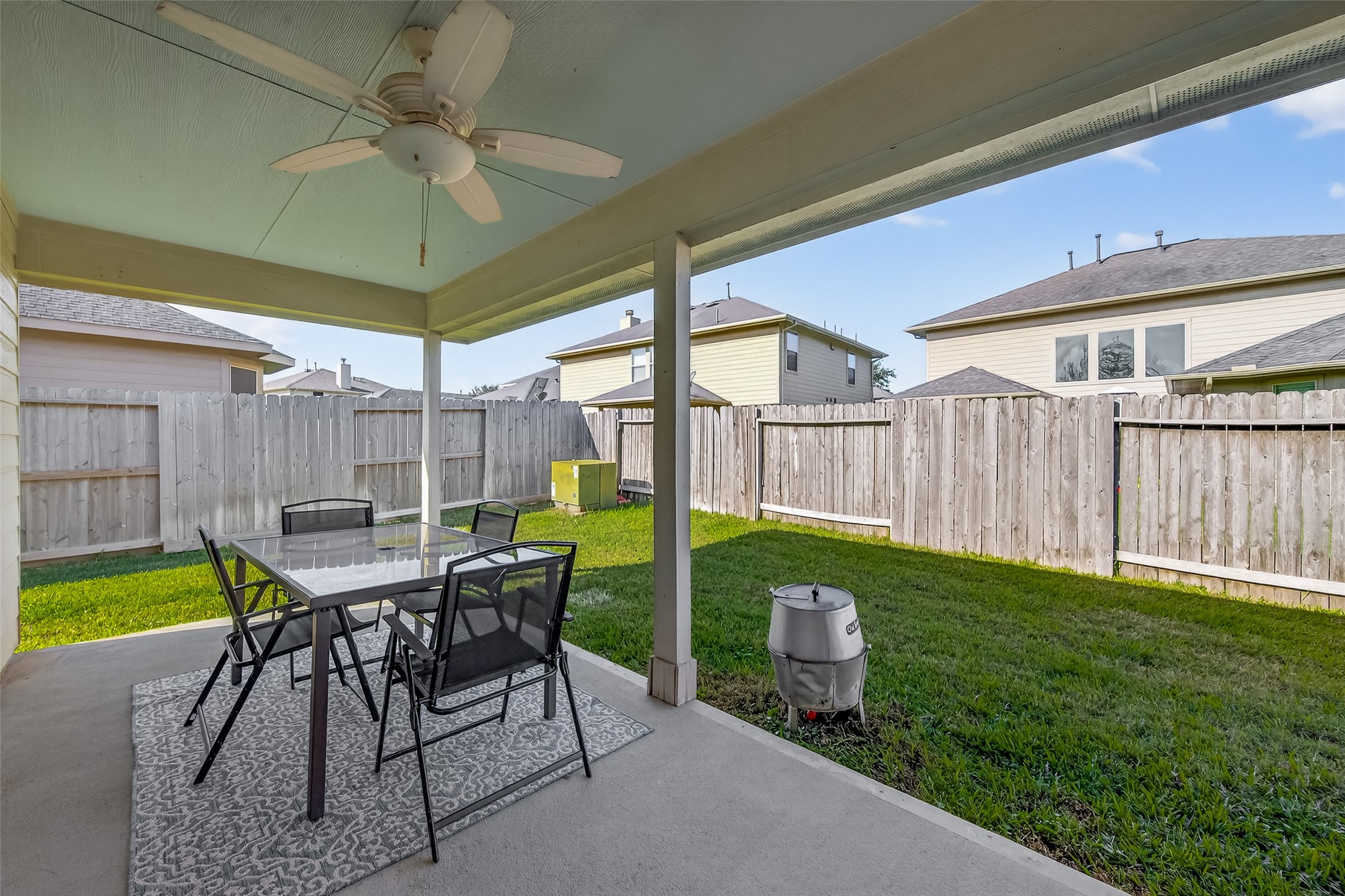 15607 Mossy Park Cypress, TX 77429 - Photo 32 of 34 a view of a patio with a table and chairs under an umbrella
