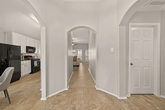a view of a hallway with a dining area