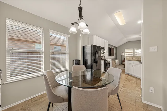 a dining room with furniture and window