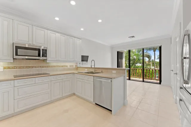 a view of an empty room with wooden floor and a sliding door