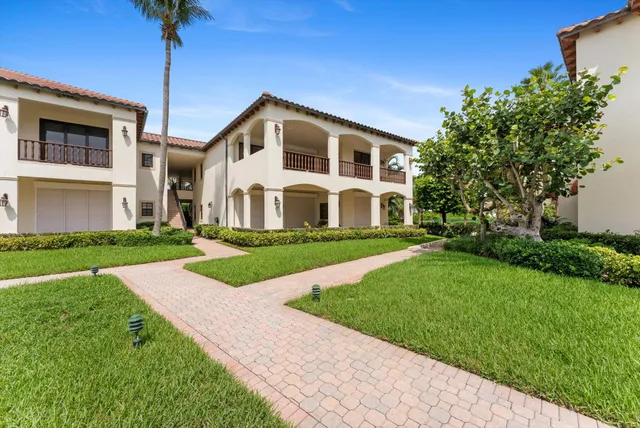 a view of a porch with a table and chairs