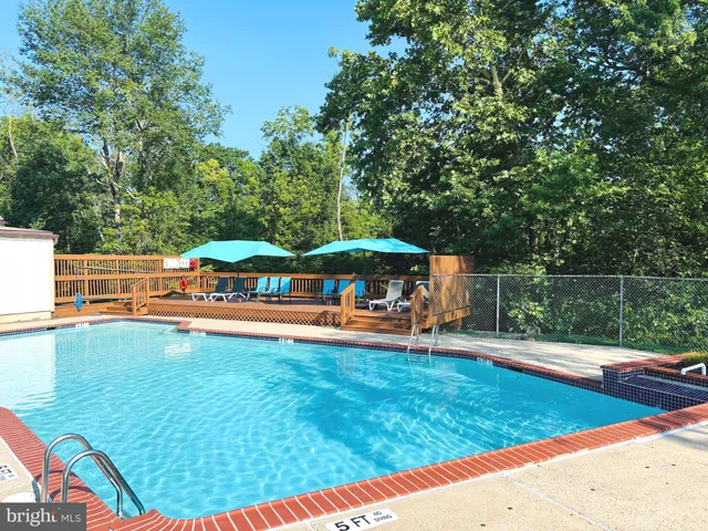 a view of backyard with swimming pool