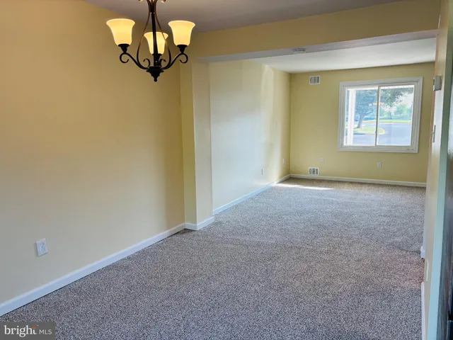 a view of a room with a window and a ceiling fan