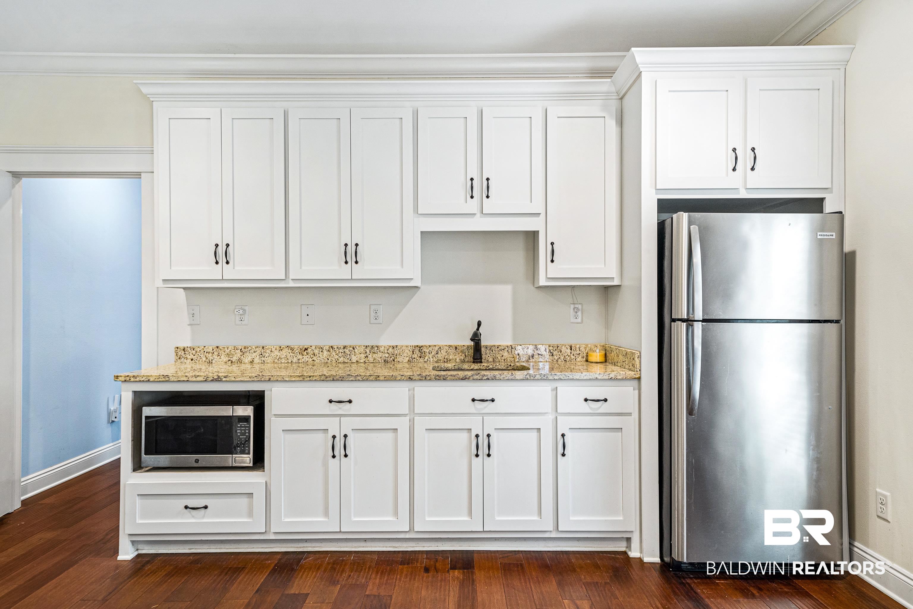 36784 Legacy Way Bay Minette, AL 36507 - Photo 33 of 57 Additional suite "Kitchen" area with light stone counters, refrigerator and microwave.