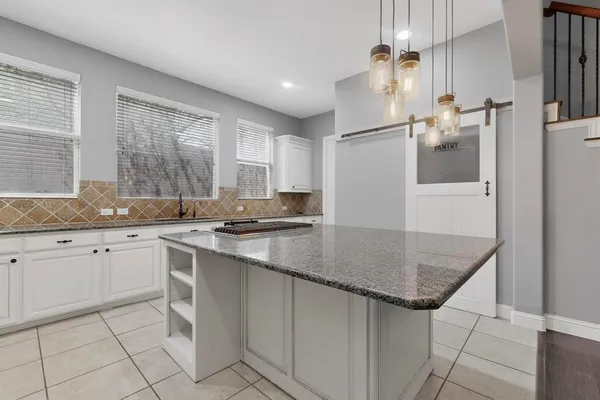 a kitchen with stainless steel appliances granite countertop a sink refrigerator and cabinets