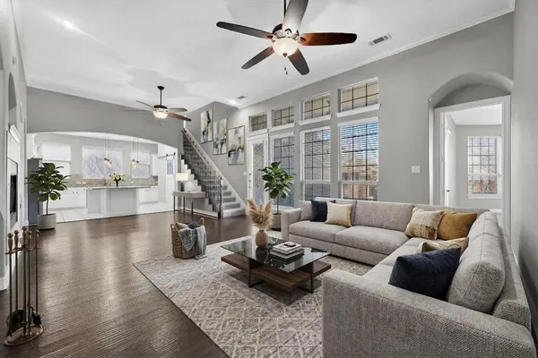 a living room with furniture and wooden floor