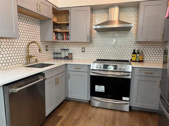 a kitchen with a stove and a sink