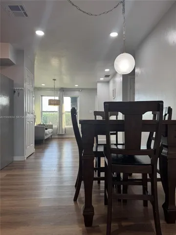 a view of a dining room with furniture and wooden floor