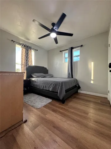 a living room with a bed furniture and a large window