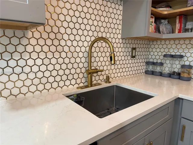 a kitchen with a sink and a microwave