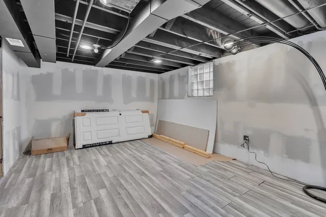 a view of a room with wooden floor