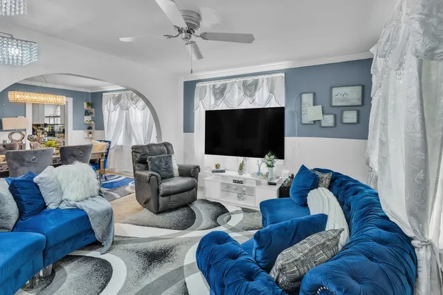 a living room with furniture and a flat screen tv