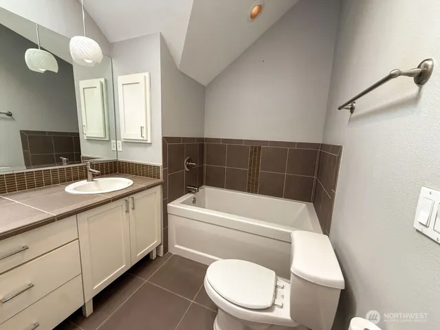 a bathroom with a sink a toilet and tub
