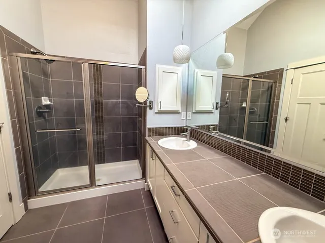 a bathroom with a sink a toilet and shower