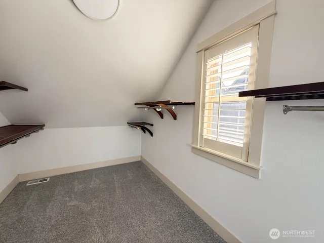 a view of a room with rack on the wall and a window