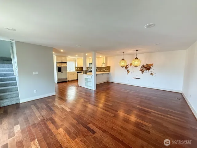 a view of a livingroom with furniture wooden floor and a window