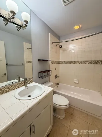 a bathroom with a sink a toilet and a shower