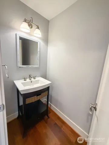 a bathroom with a sink mirror and vanity