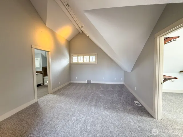 an empty room with a bathroom and a vanity