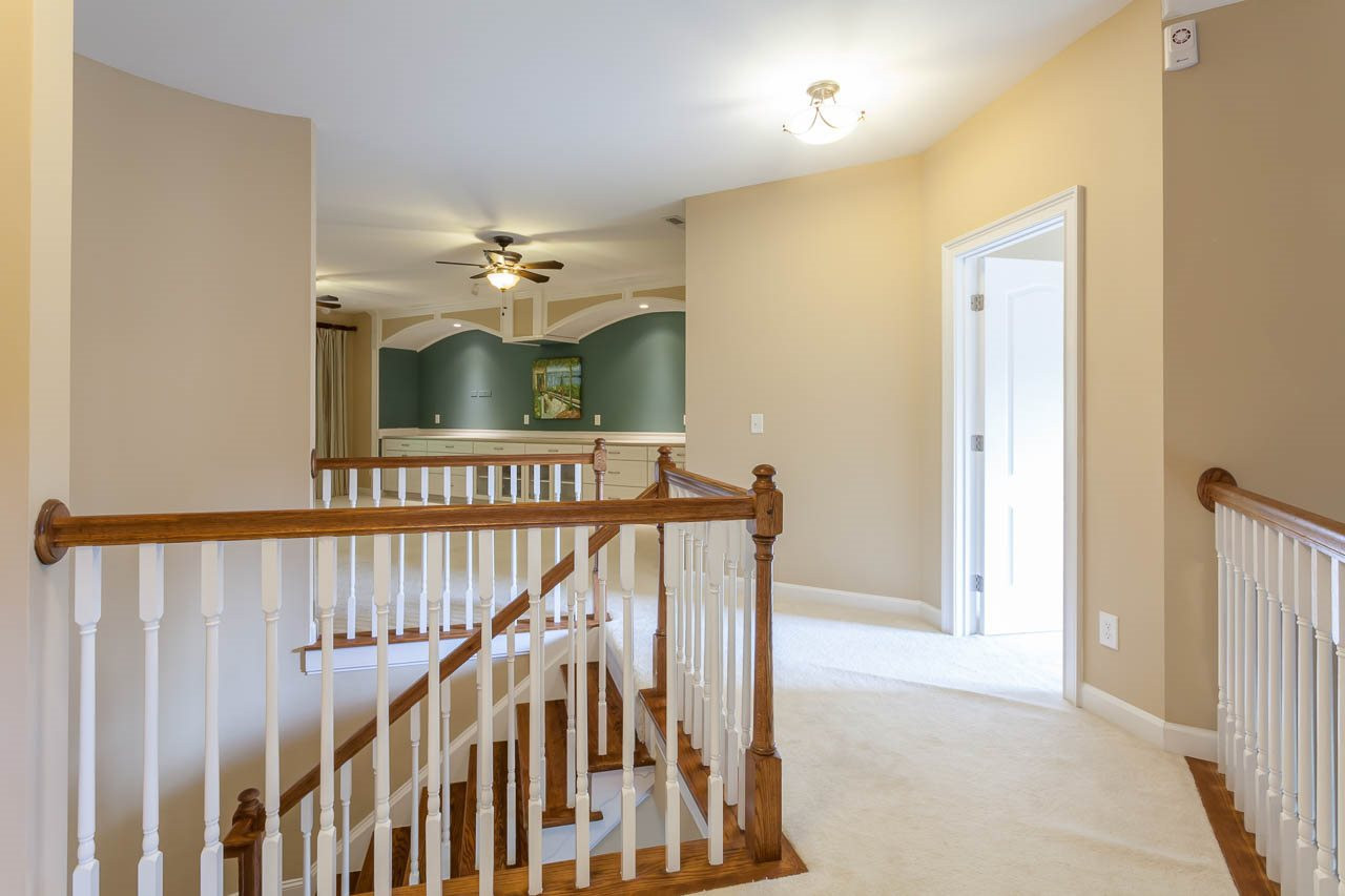 8000 Jessamine Way Raleigh, NC 27612 - Photo 13 of 25 This is a view of the second floor landing as it leads to the bedrooms and media/bonus rooms. Not captured in this photo is the beautiful curved staircase that leads to the landing. 2nd Floor Landing