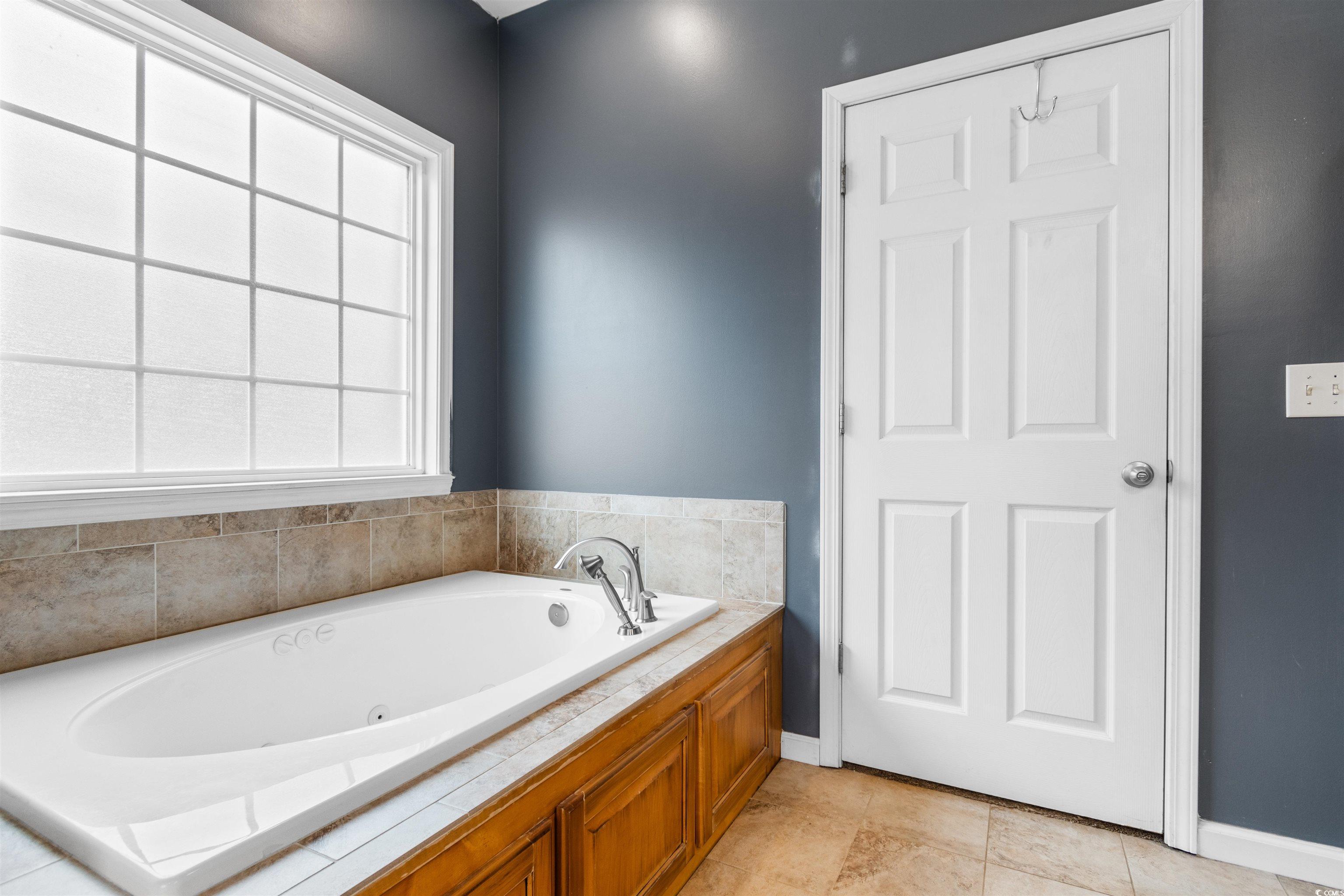 1291 Pisgah Church Road Aynor, SC 29511 - Photo 22 of 39 Bathroom with tile patterned floors and a tub