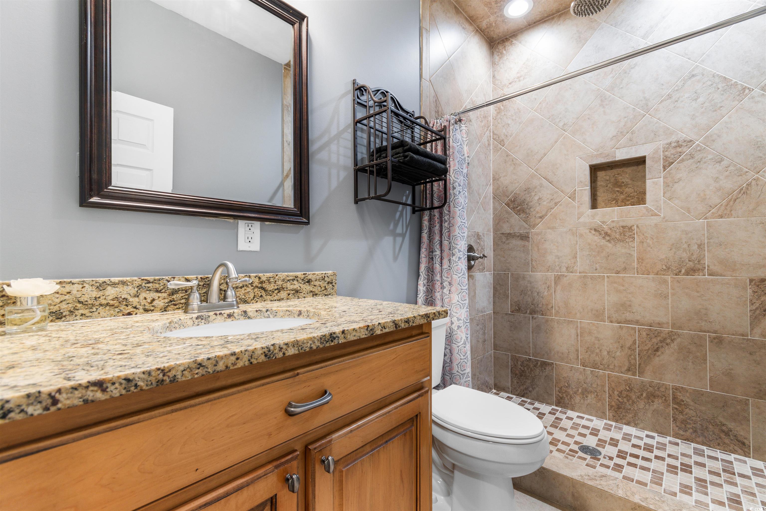 1291 Pisgah Church Road Aynor, SC 29511 - Photo 25 of 39 Bathroom with tiled shower, vanity, and toilet