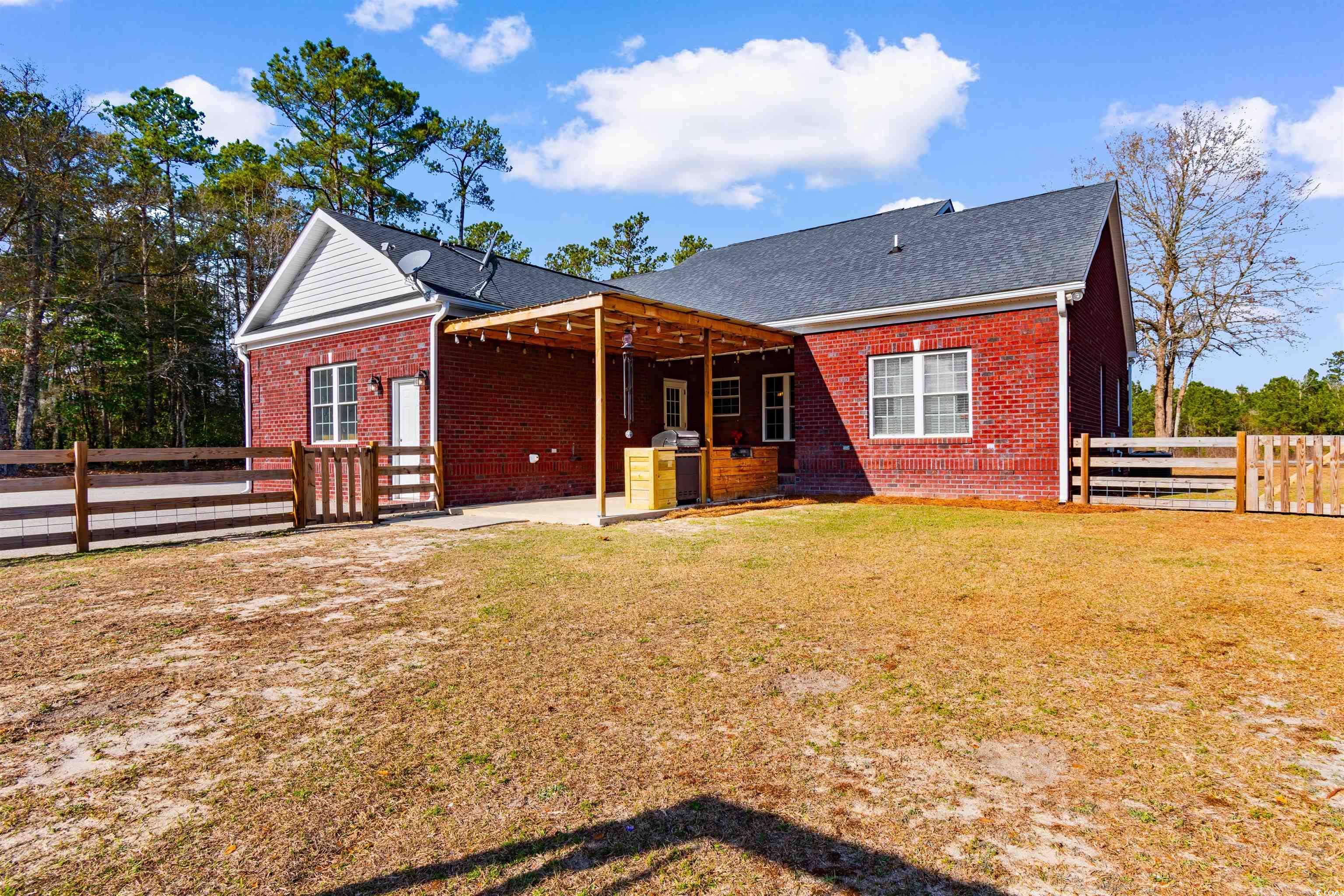 1291 Pisgah Church Road Aynor, SC 29511 - Photo 36 of 39 Rear view of house featuring a yard