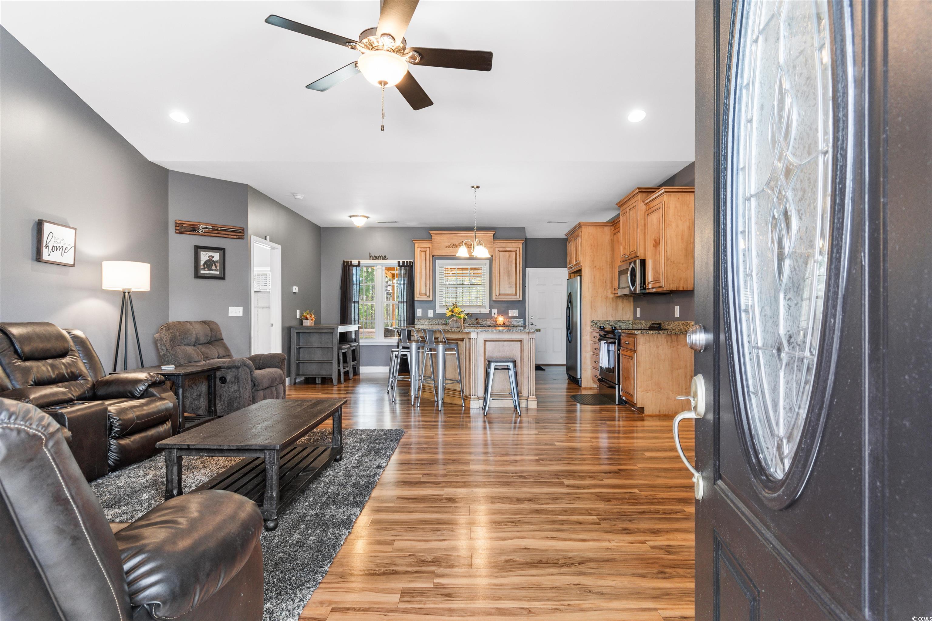 1291 Pisgah Church Road Aynor, SC 29511 - Photo 8 of 39 Living room with ceiling fan with notable chandeli