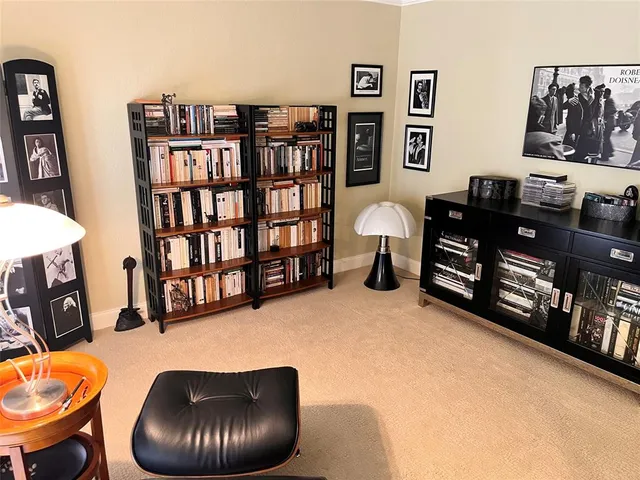 a living room with lots of furniture and book shelf